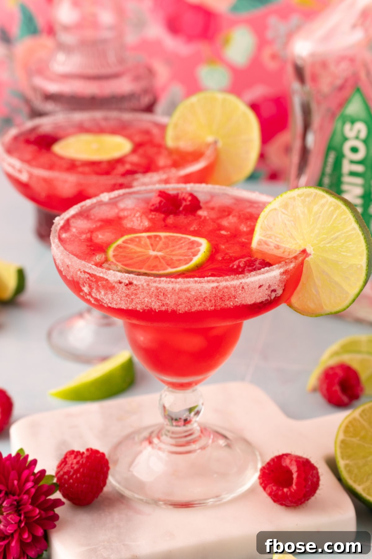 Raspberry margarita on a marble coaster.
