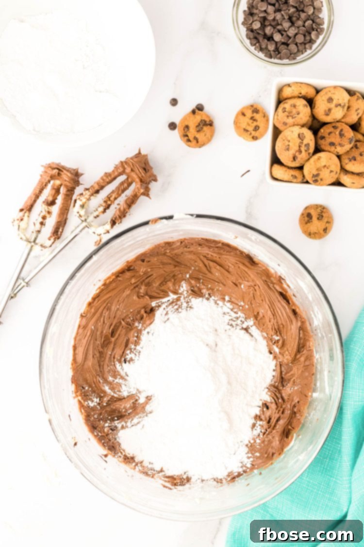 Powdered sugar being added to chocolate and butter to make frosting.