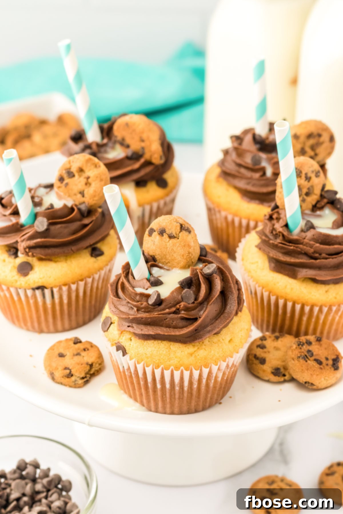 Milk and Cookies cupcakes on a white cake stand.