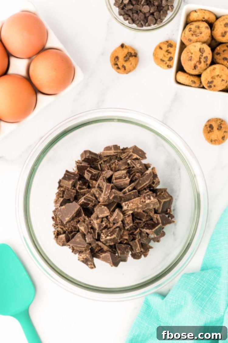 Chopped chocolate in a glass mixing bowl.