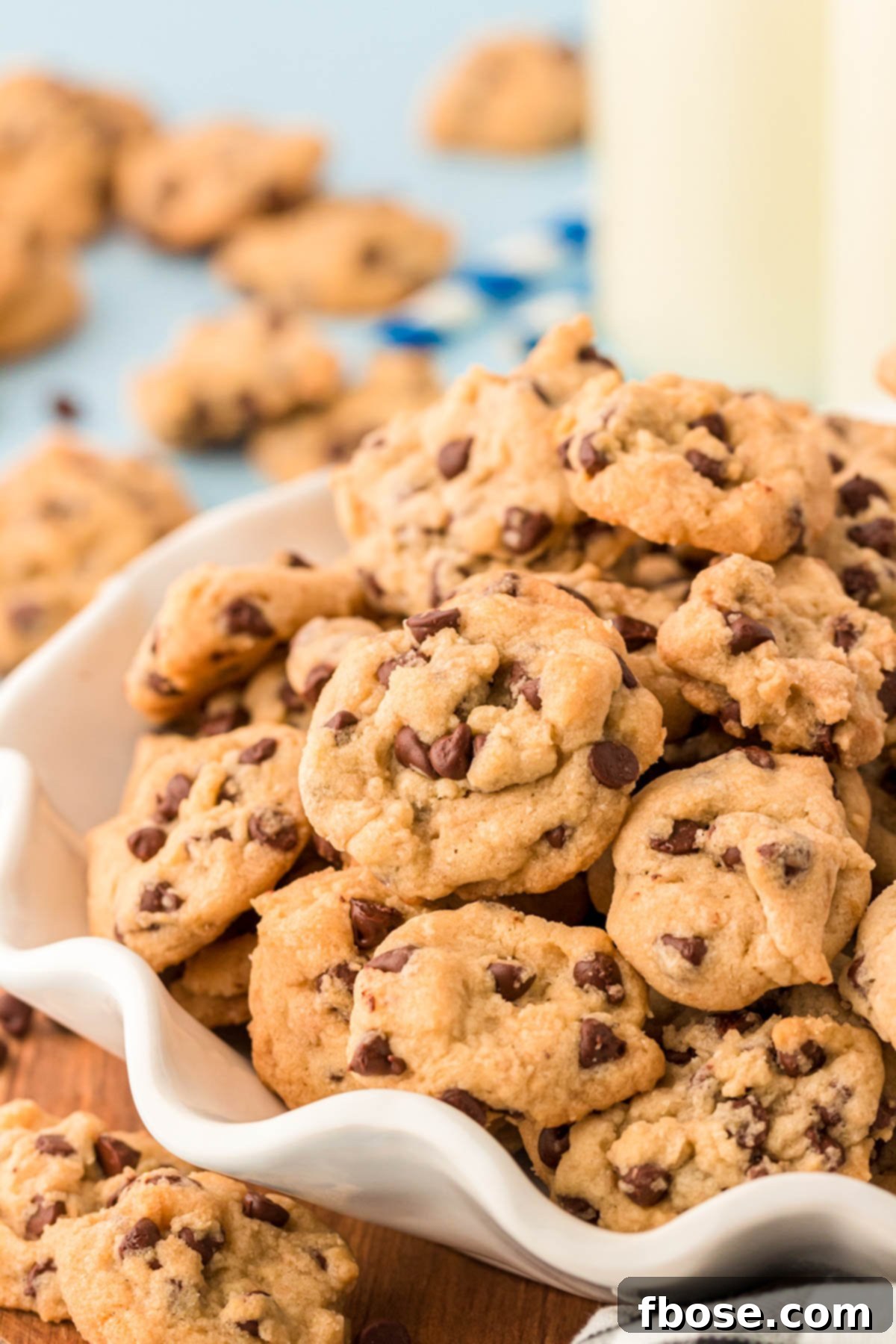 A bowl filled with mini chocolate chip cookies.