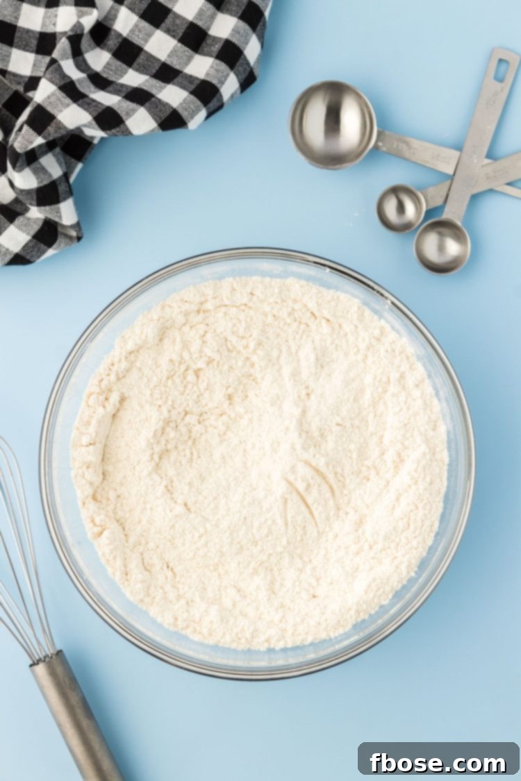 Vanilla being poured into cookie dough.