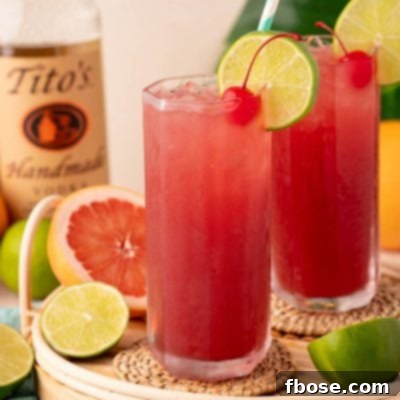 Two sea breeze cocktails on a rattan tray.