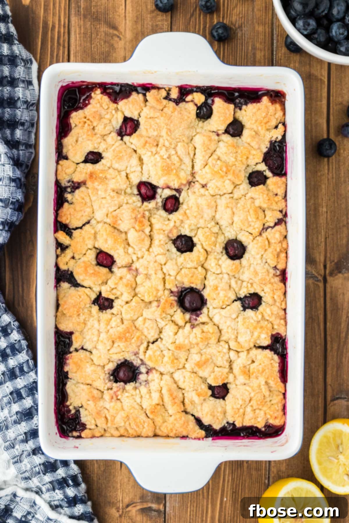 Overhead photo of blueberry cobbler on a wooden table.