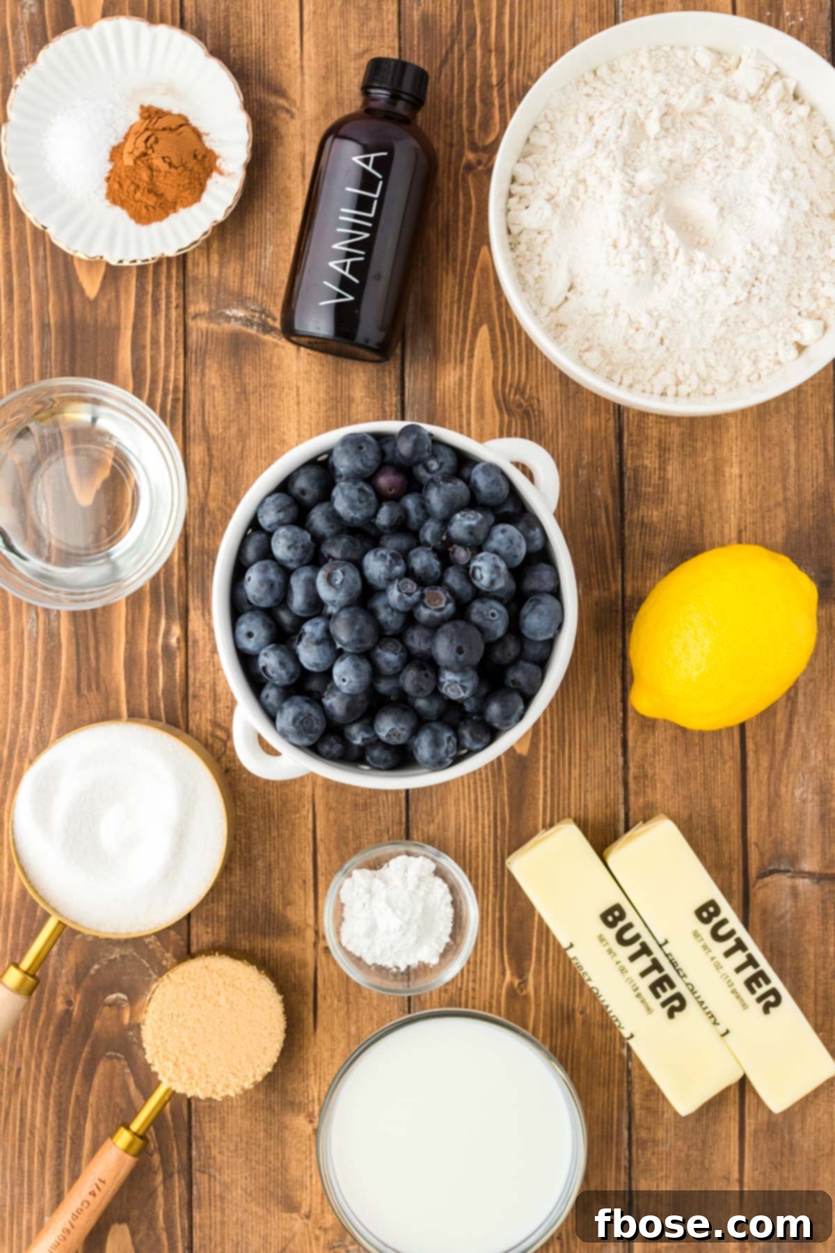 Ingredients to make blueberry cobbler on a wooden table.