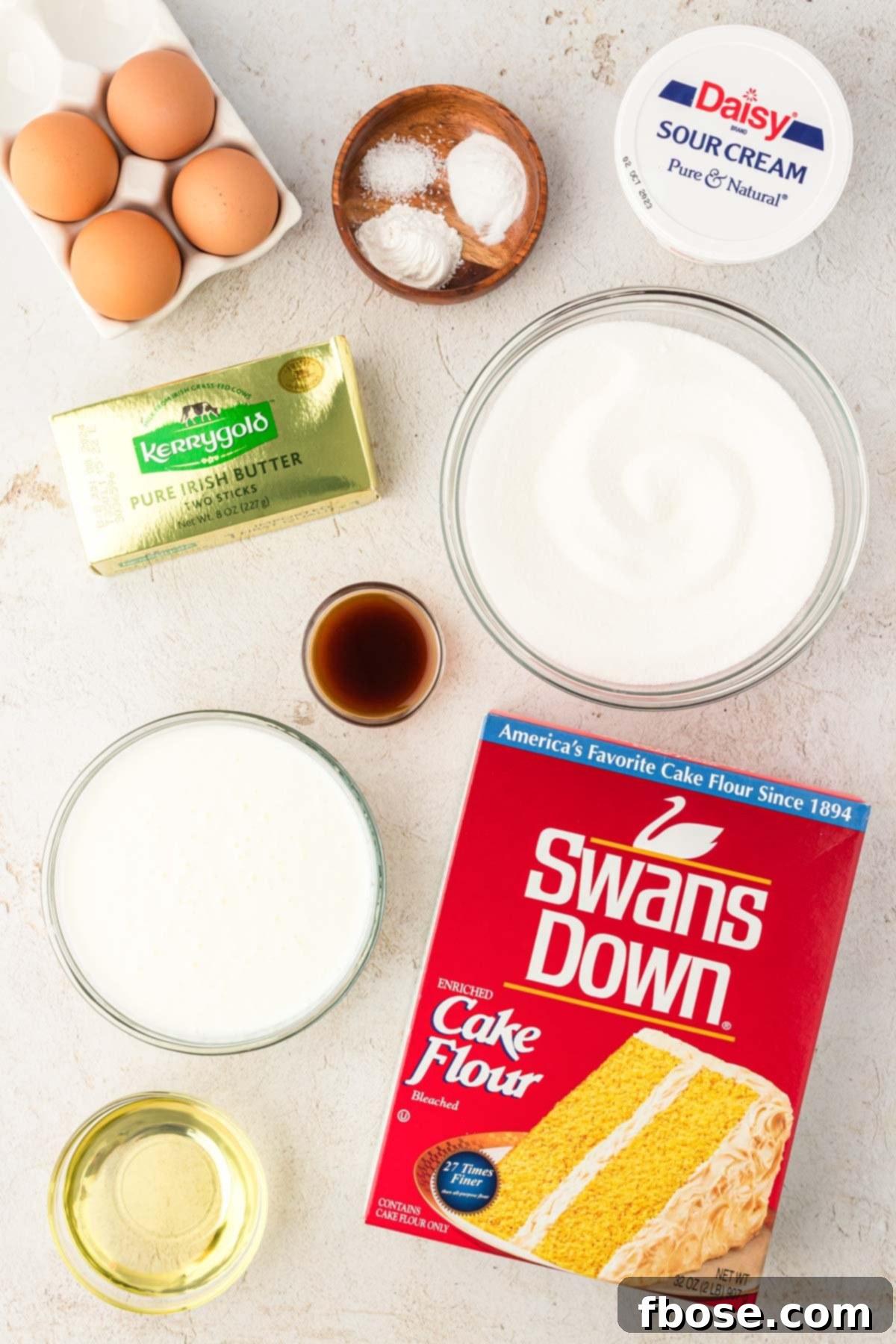 Overhead photo of all the ingredients meticulously laid out, ready to be used to make yellow cupcakes.