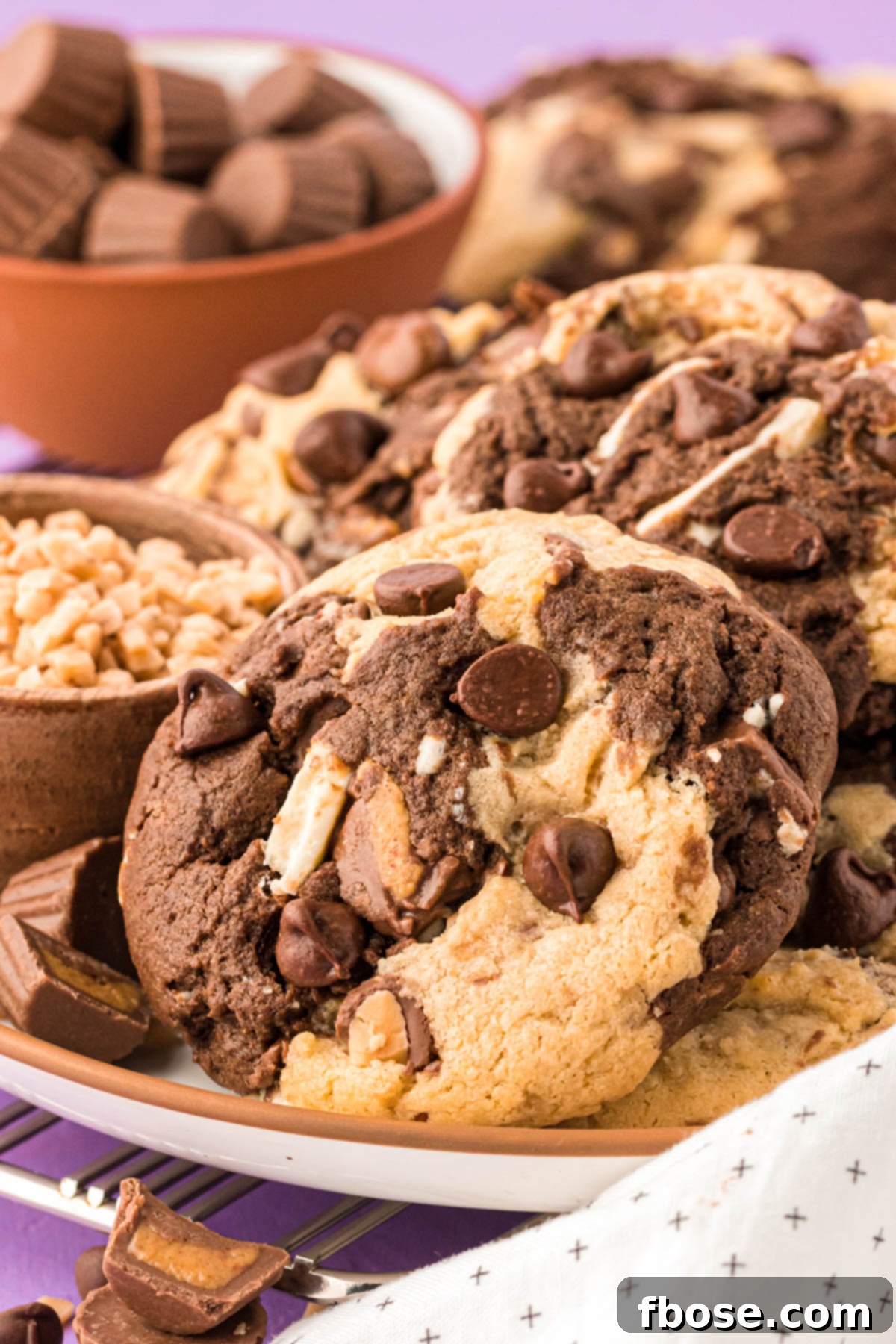 A beautifully arranged plate of Kitchen Sink Cookies, showcasing their rich, varied textures and tempting golden-brown edges.