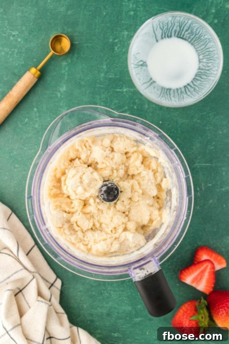 Classic Strawberry Cobbler 14 The perfectly textured biscuit cobbler topping in a food processor, ready to be spread over the fruit filling.