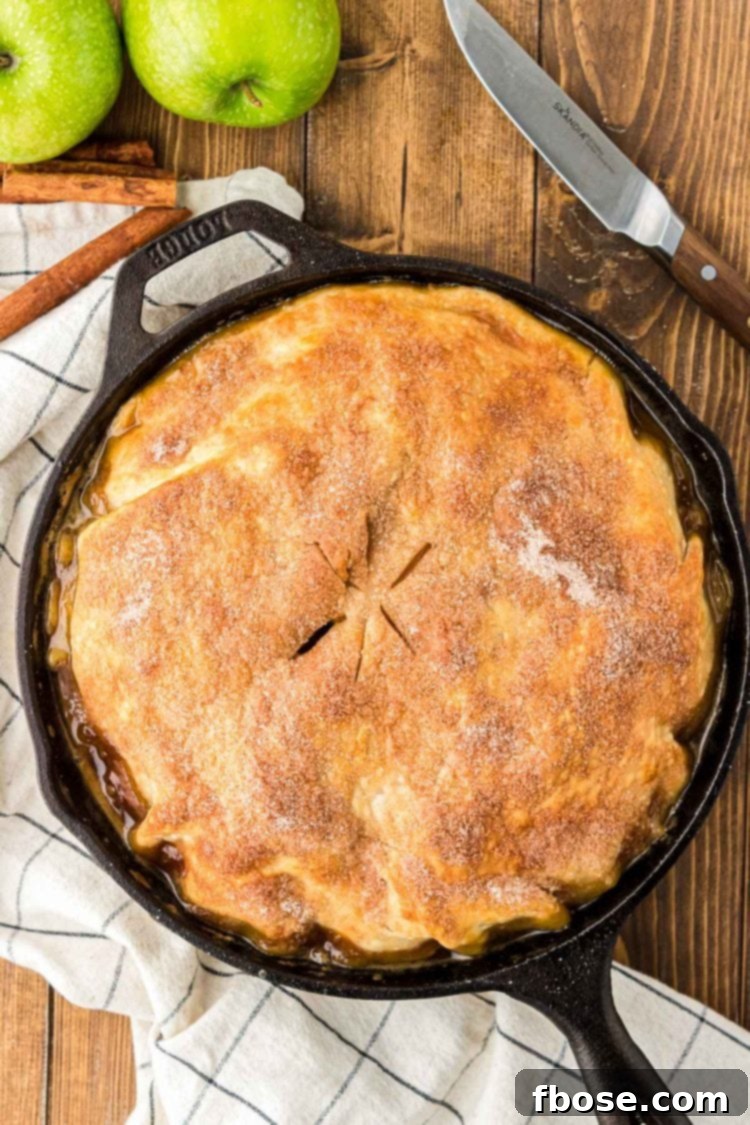 A baked apple pandowdy in a skillet.