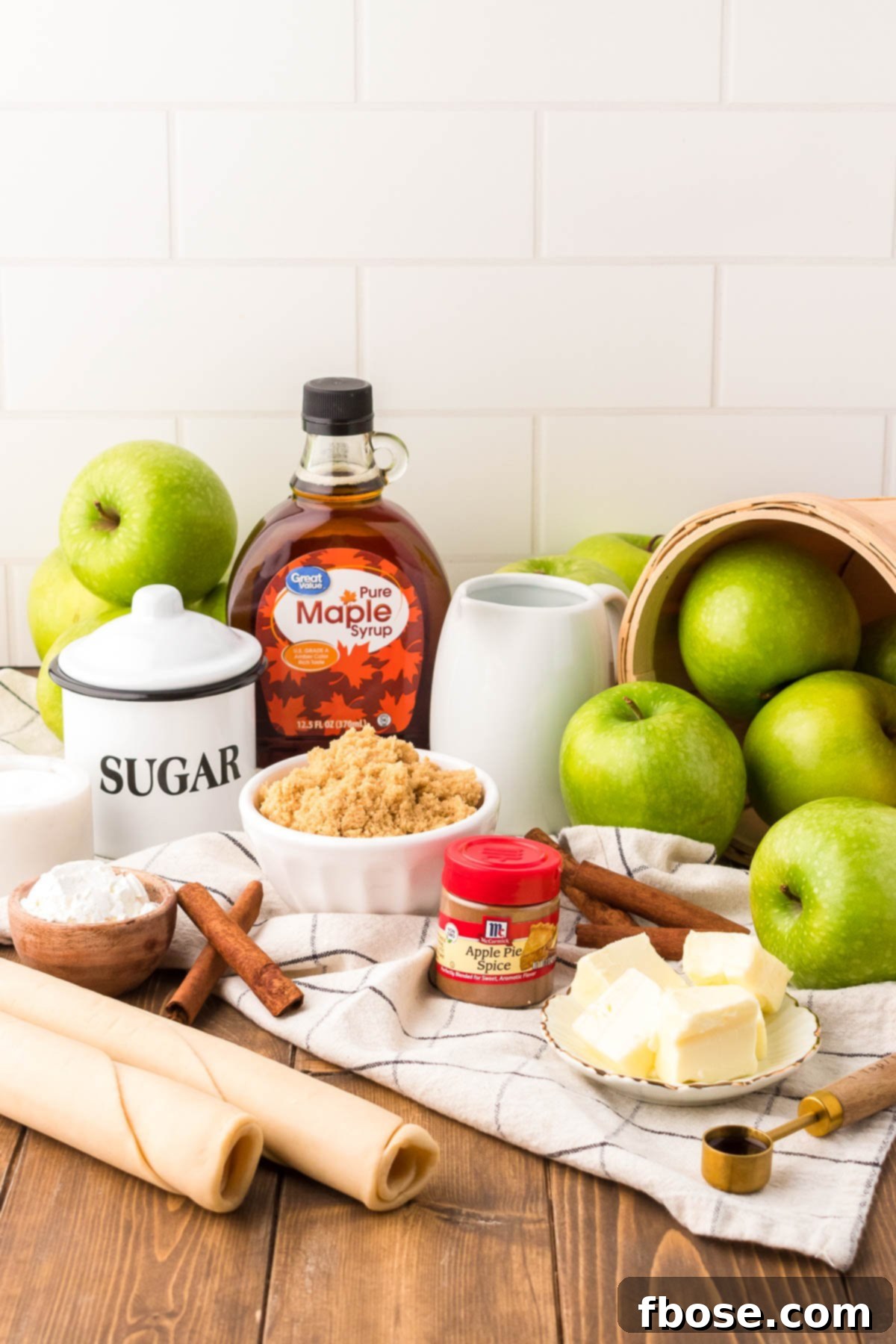 Ingredients to make apple pan dowdy on a wooden table.