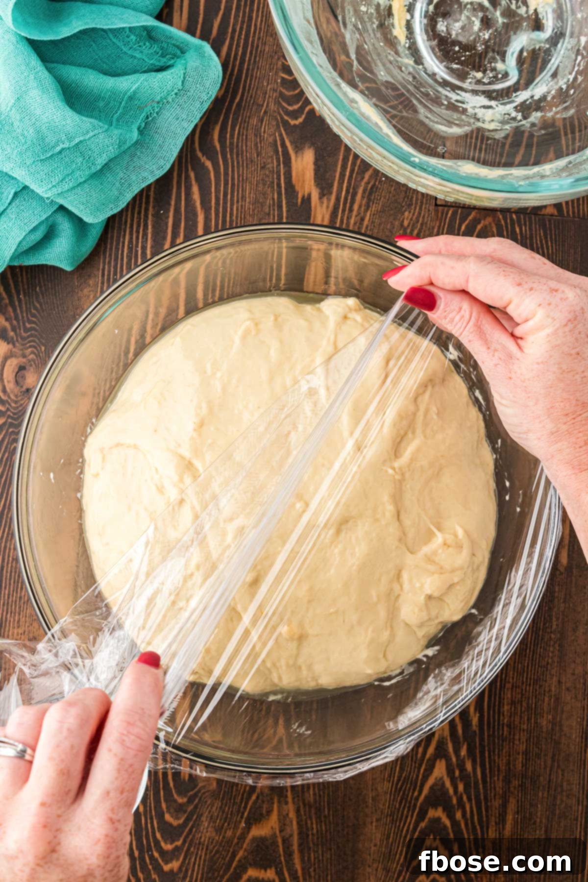 Cinnamon roll dough going in a bowl to rise. 