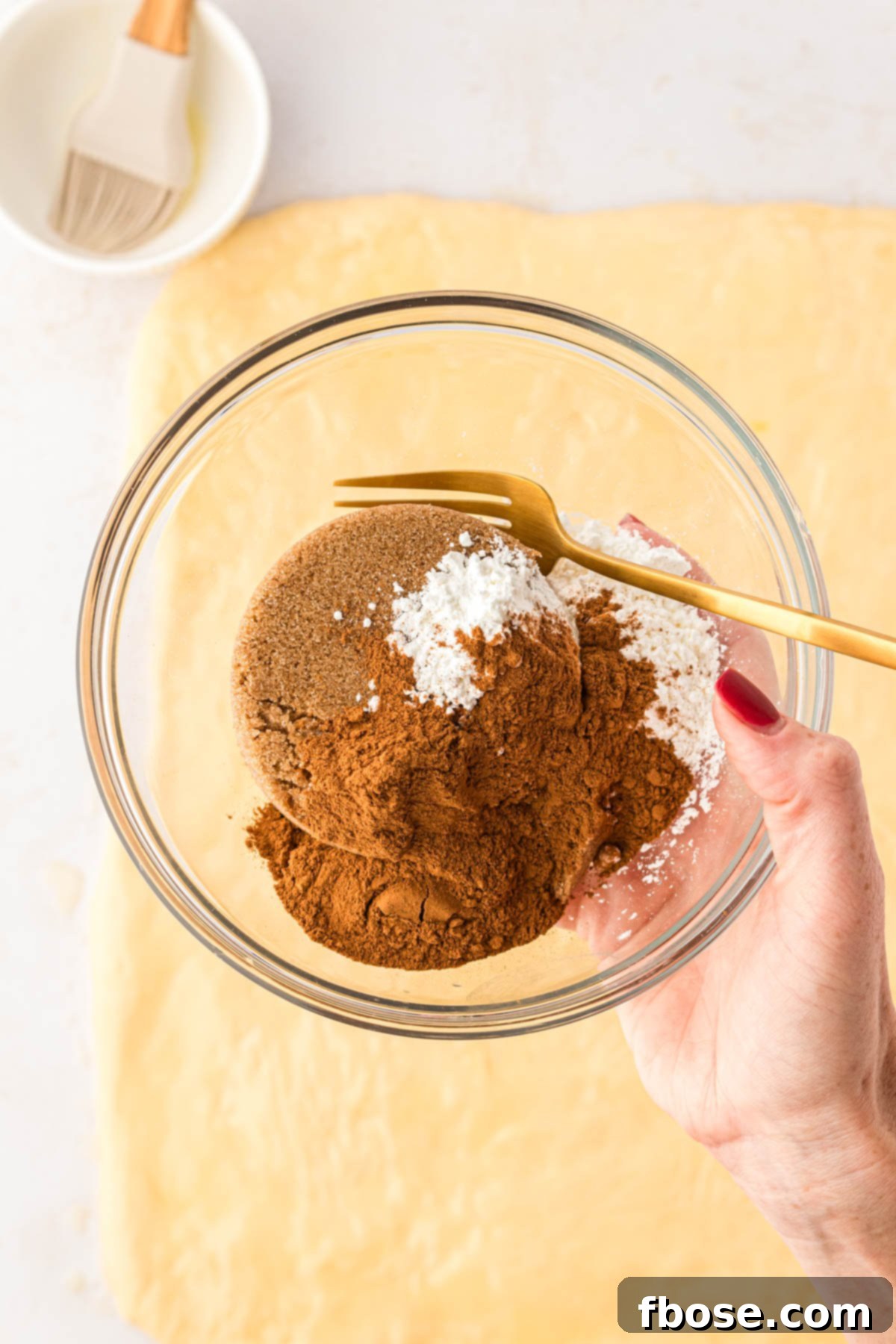 Dark brown sugar, cinnamon, and cornstarch in a small bowl.