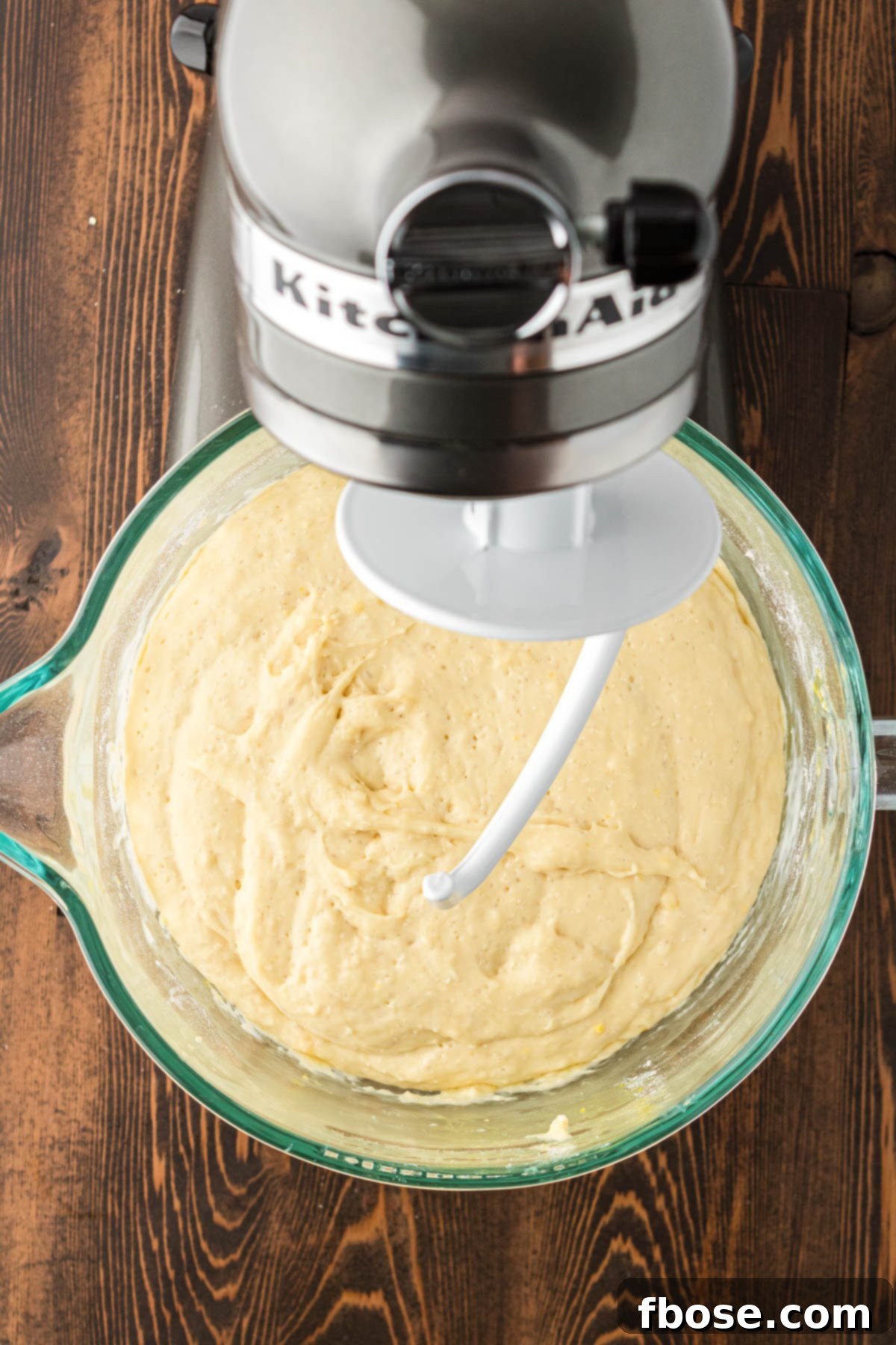 Cinnamon rolls in a stand mixer bowl ready to be kneaded.