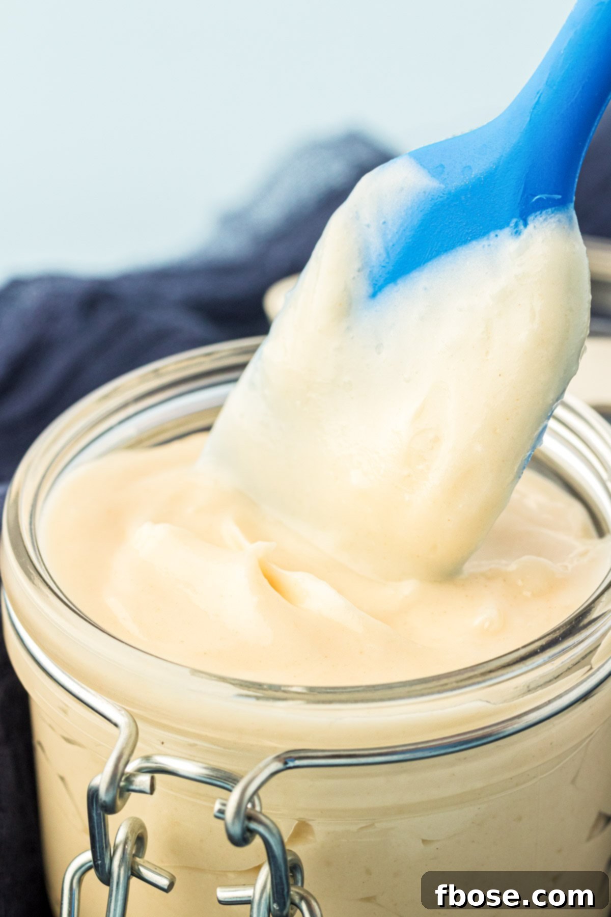 Flawless Cake Release 8 A pastry brush dipping into a jar of cake goop, ready for use, highlighting its texture.