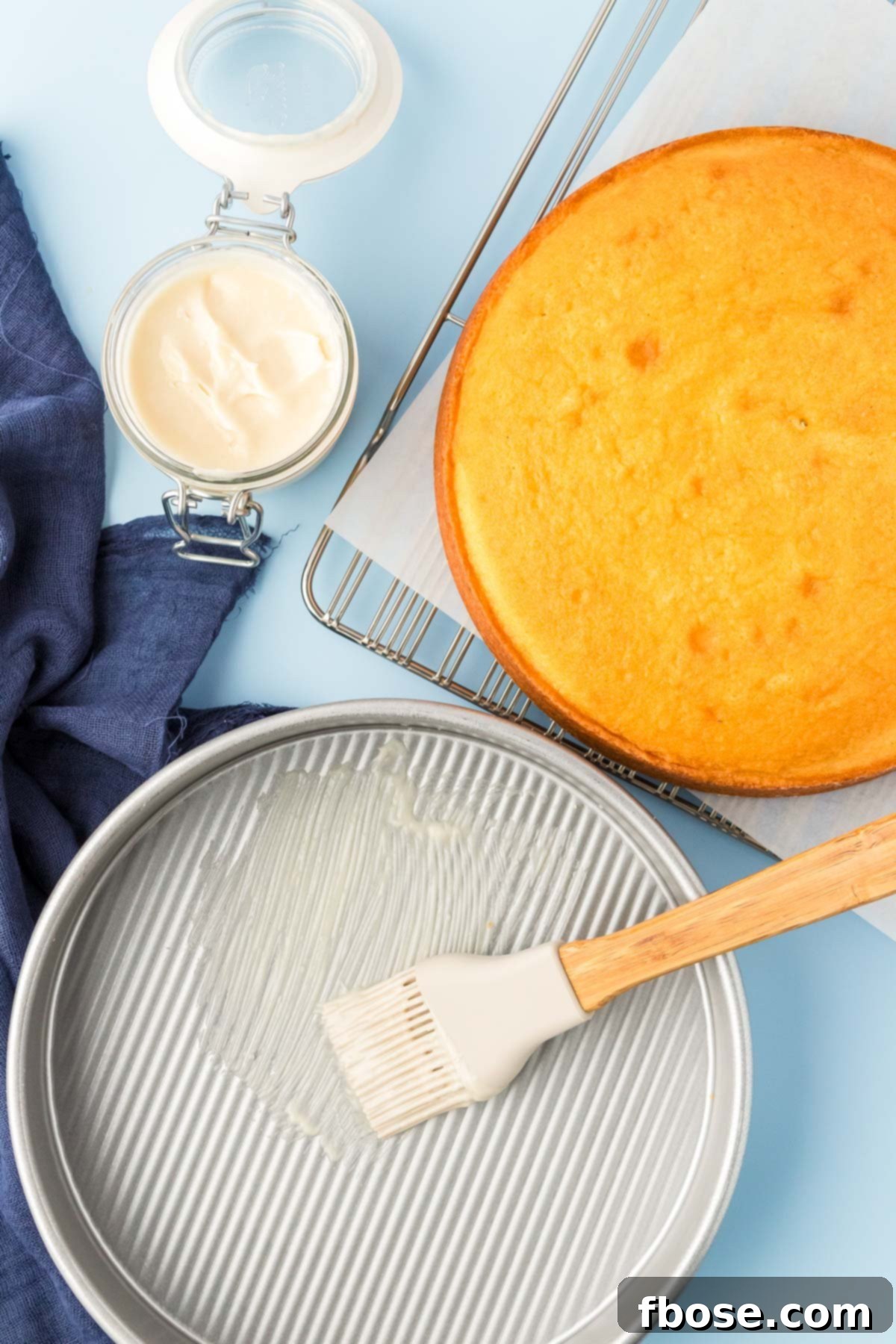 Flawless Cake Release 9 Cake goop being spread in a cake pan with a baked cake next to it, illustrating its purpose.