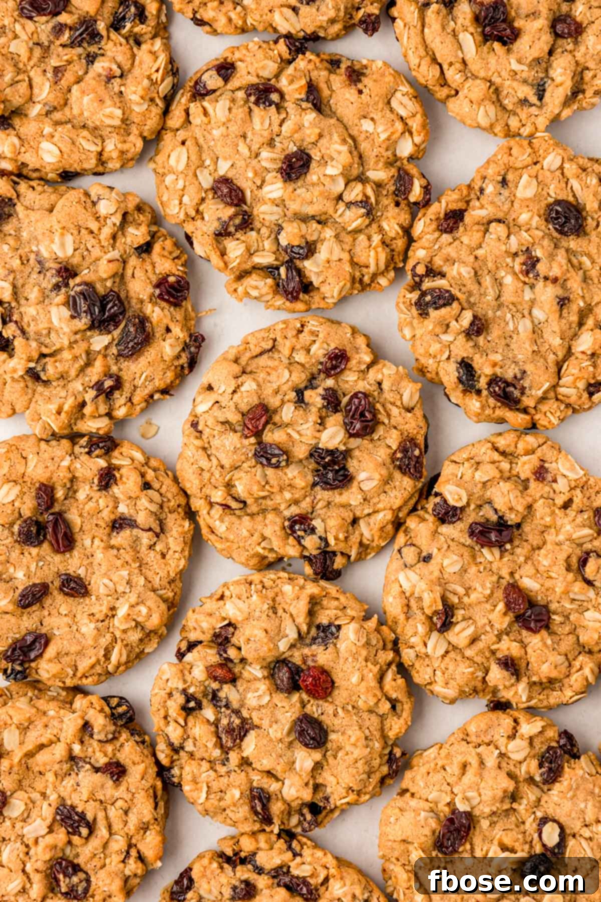 An inviting overhead shot of perfectly baked oatmeal raisin cookies, glistening and ready to be enjoyed.