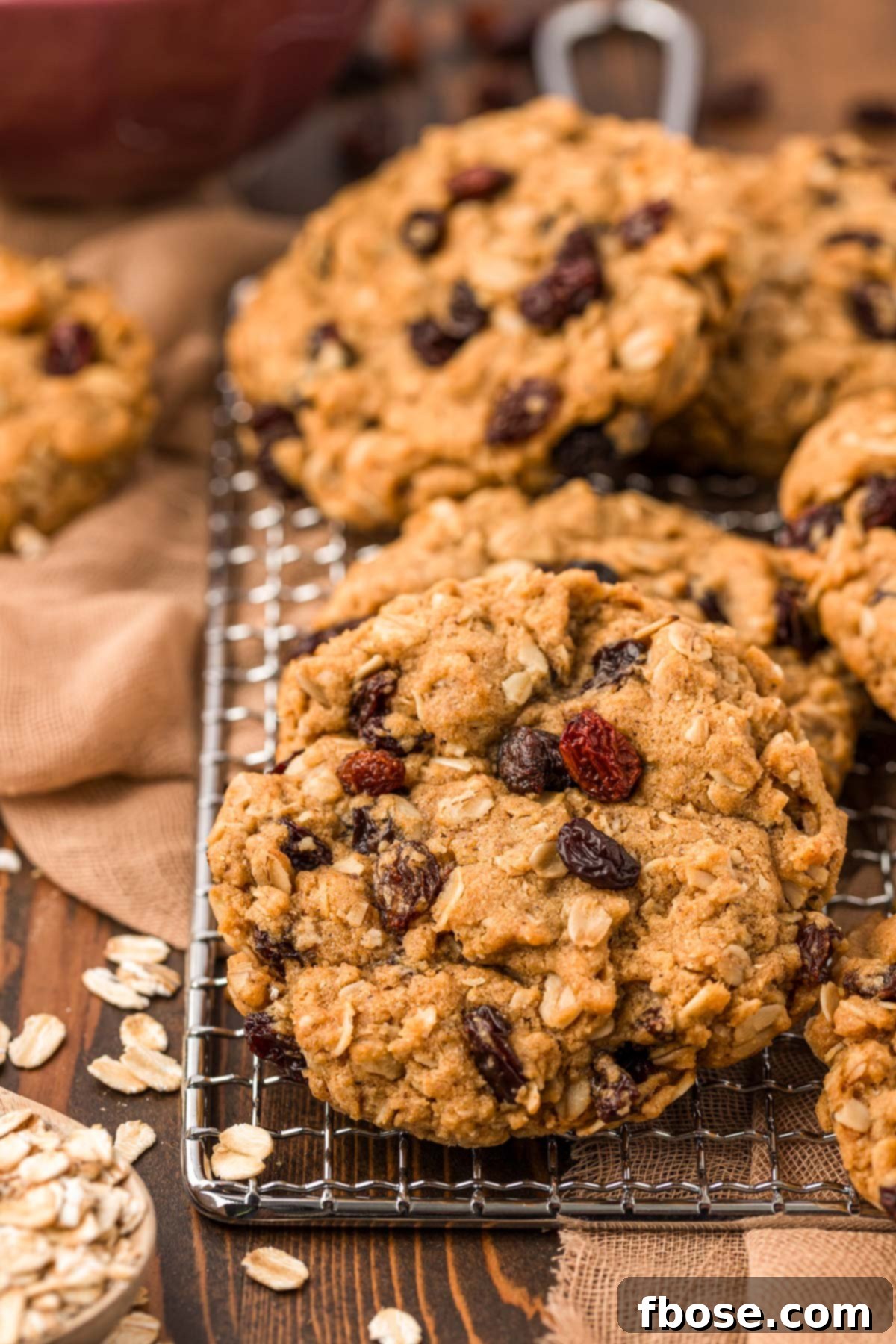 A delightful close-up shot of perfectly baked oatmeal raisin cookies, showcasing their golden texture and visible plump raisins.