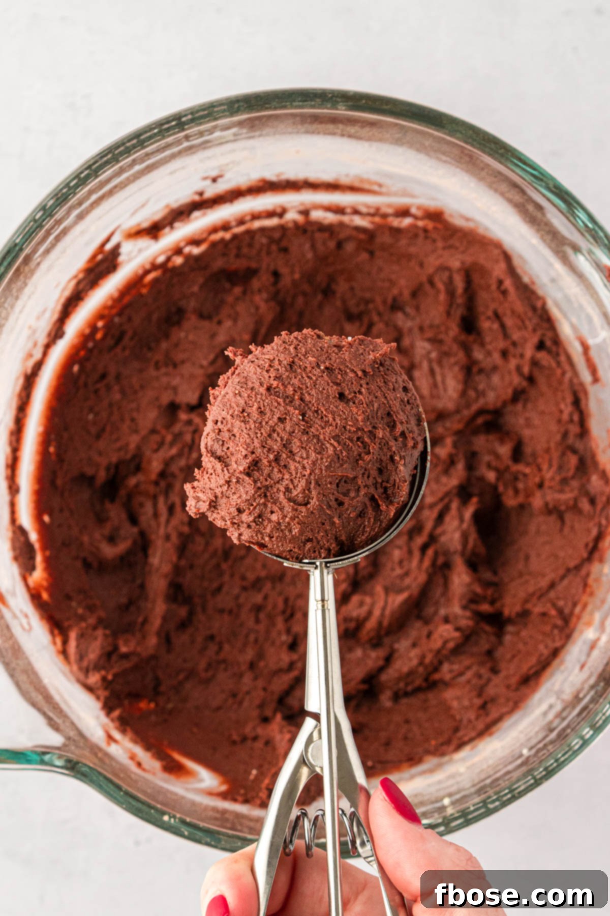Cookie scoop with chocolate cookie dough in it.