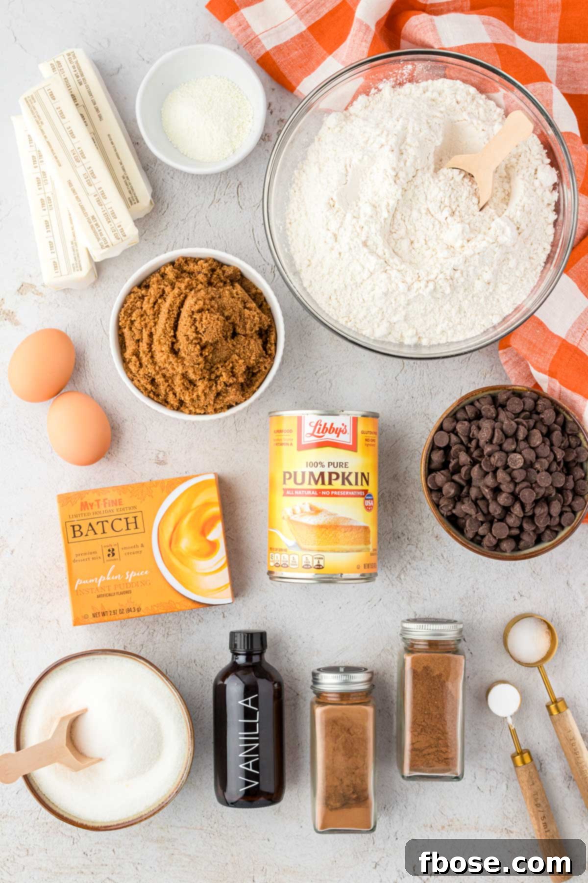 Velvety Pumpkin Chocolate Chip Delights 4 All the ingredients for pumpkin chocolate chip cookies laid out on a rustic table.
