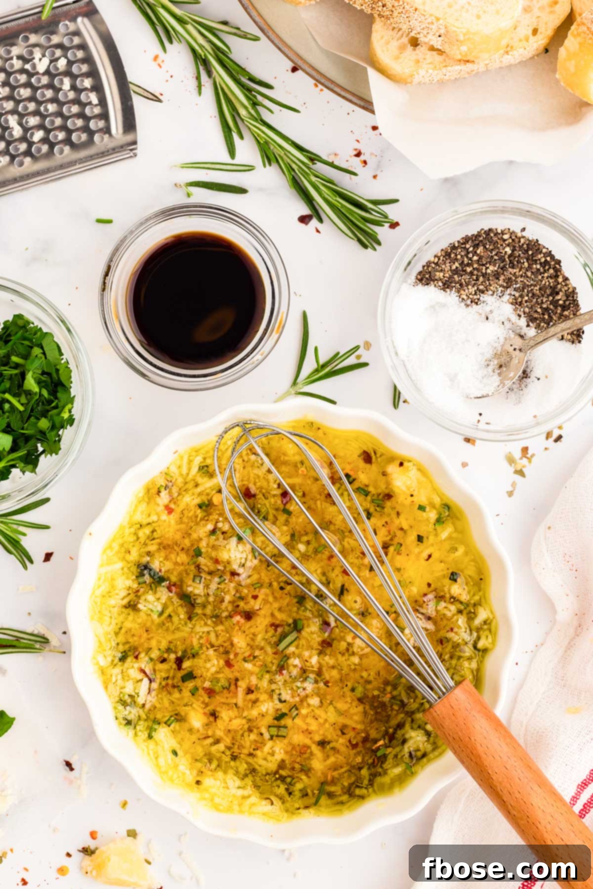 Olive oil bread dip being whisked together in a bowl.