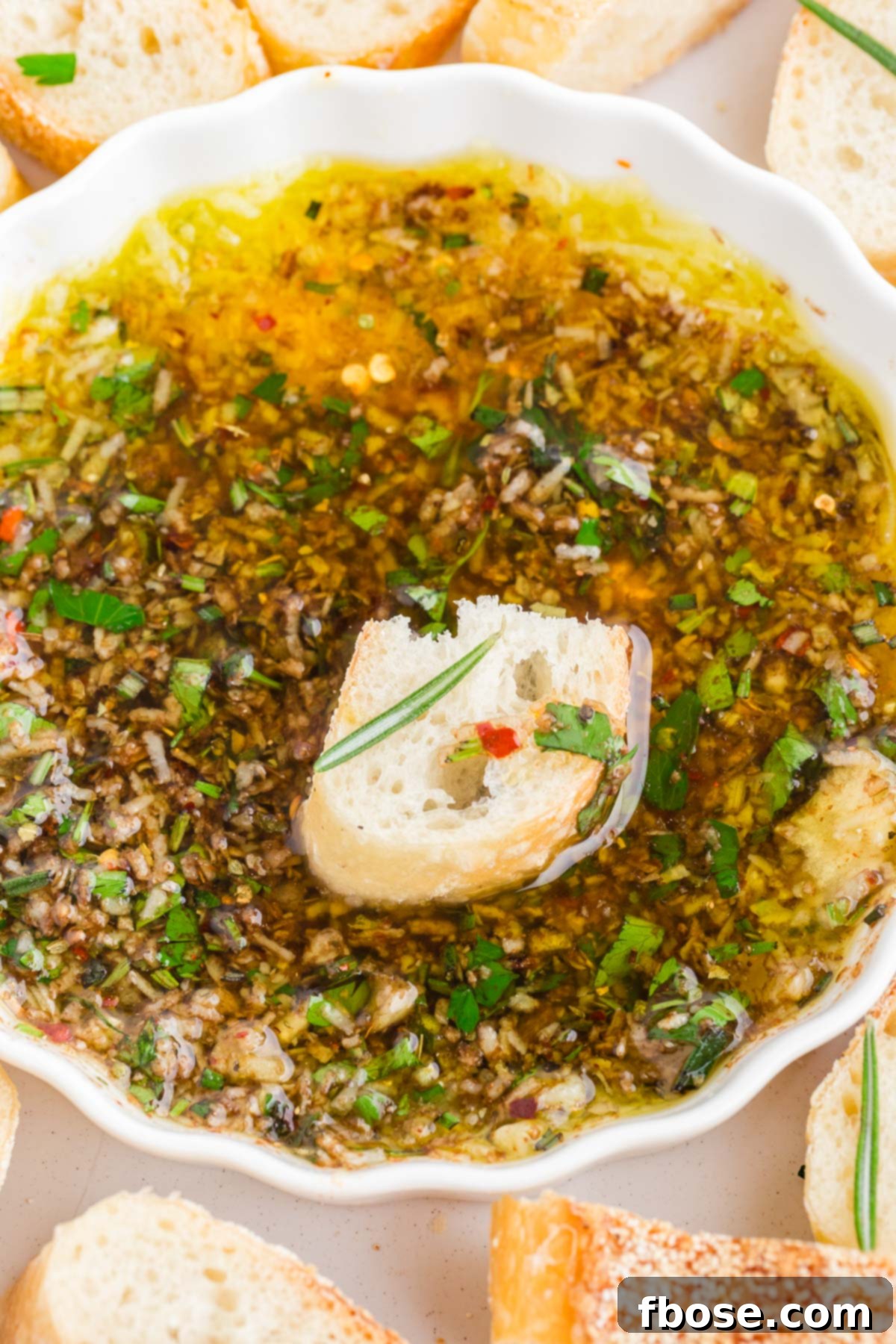 Bread in a dish of olive oil dipping sauce.