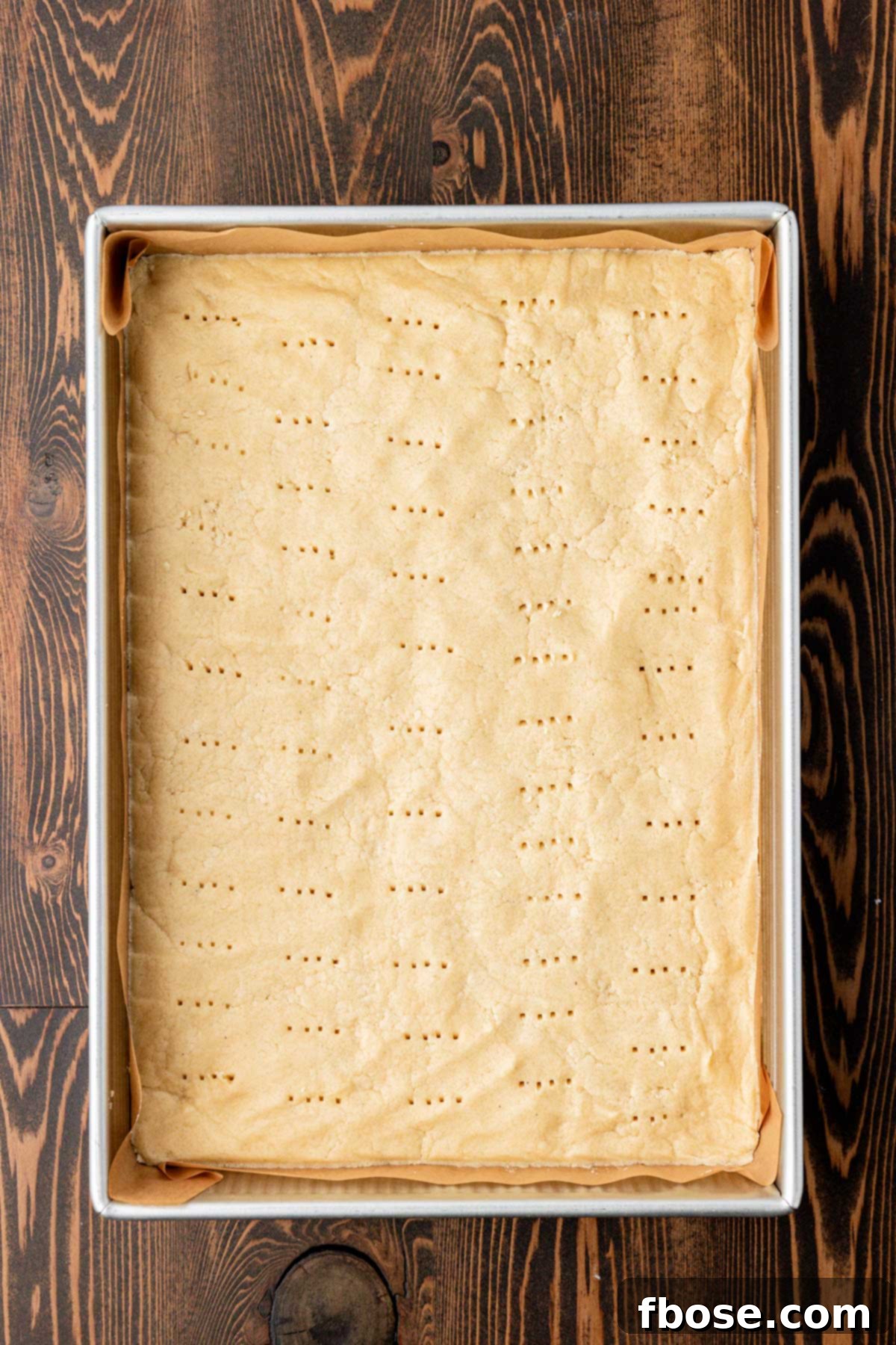 Overhead photo of a pan of shortbread cookie dough ready to bake.