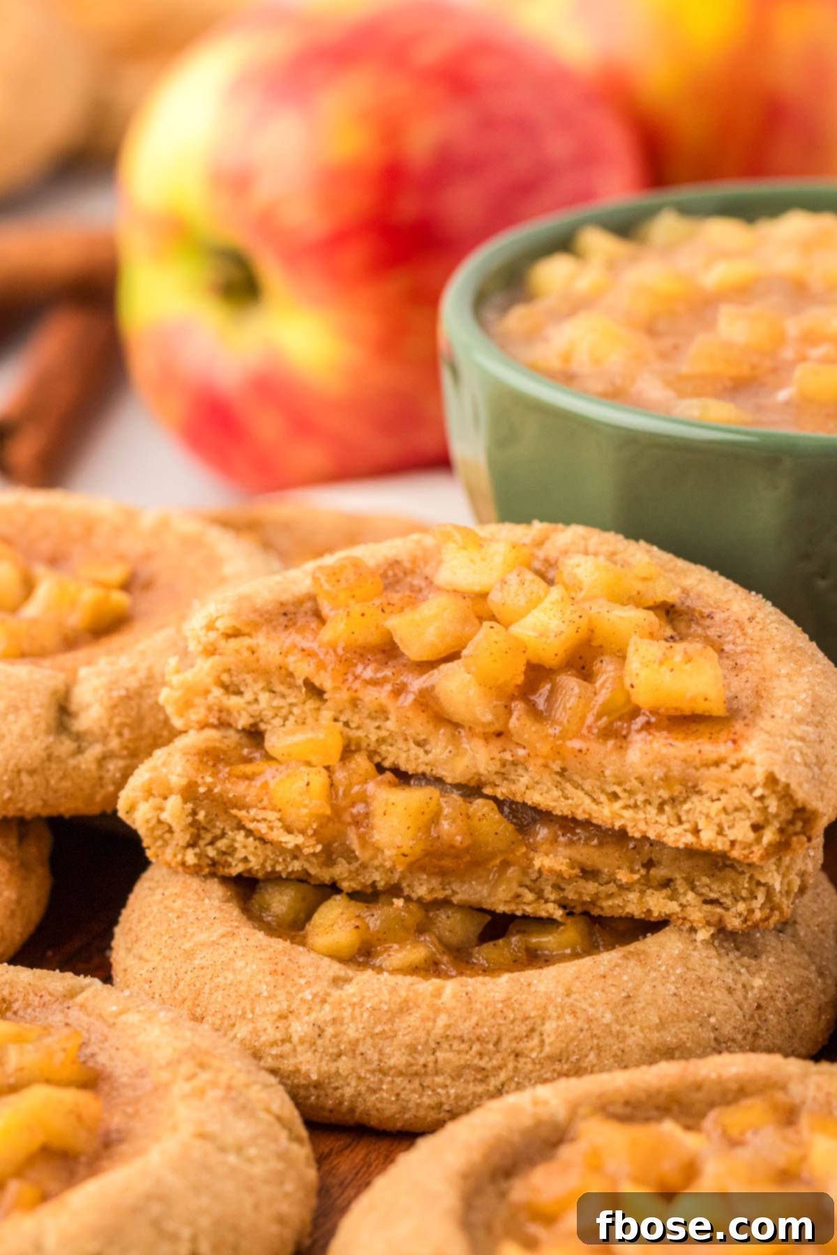 Apple pie cookies stacked.