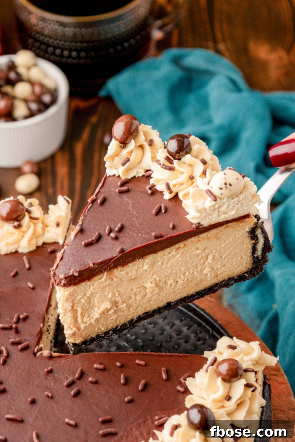 Gourmet Coffee Cheesecake 11 A slice of chocolate topped coffee cheesecake being lifted away from the rest of it.