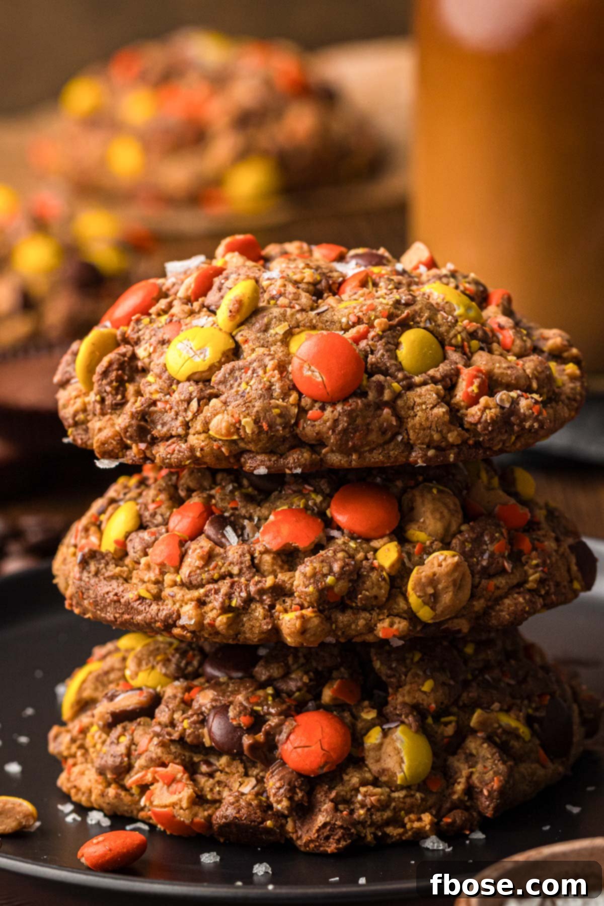 A stack of three decadent Gideon's Bakehouse-inspired Peanut Butter Cold Brew Cookies, showcasing their rich texture and candy coating.