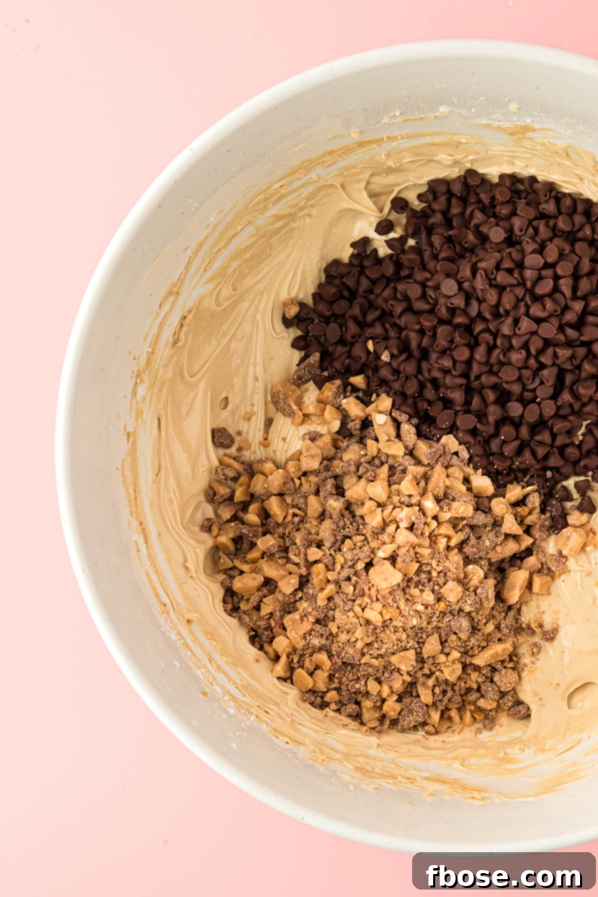 Mini chocolate chips and toffee bits being added to cookie dough dip!