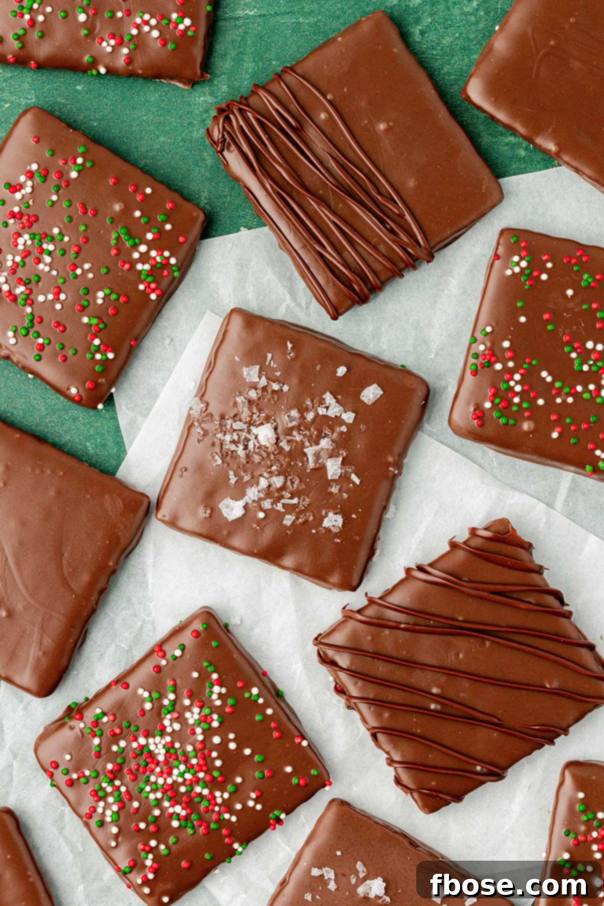 Chocolate Graham Delights 6 Chocolate covered graham crackers on parchment paper.