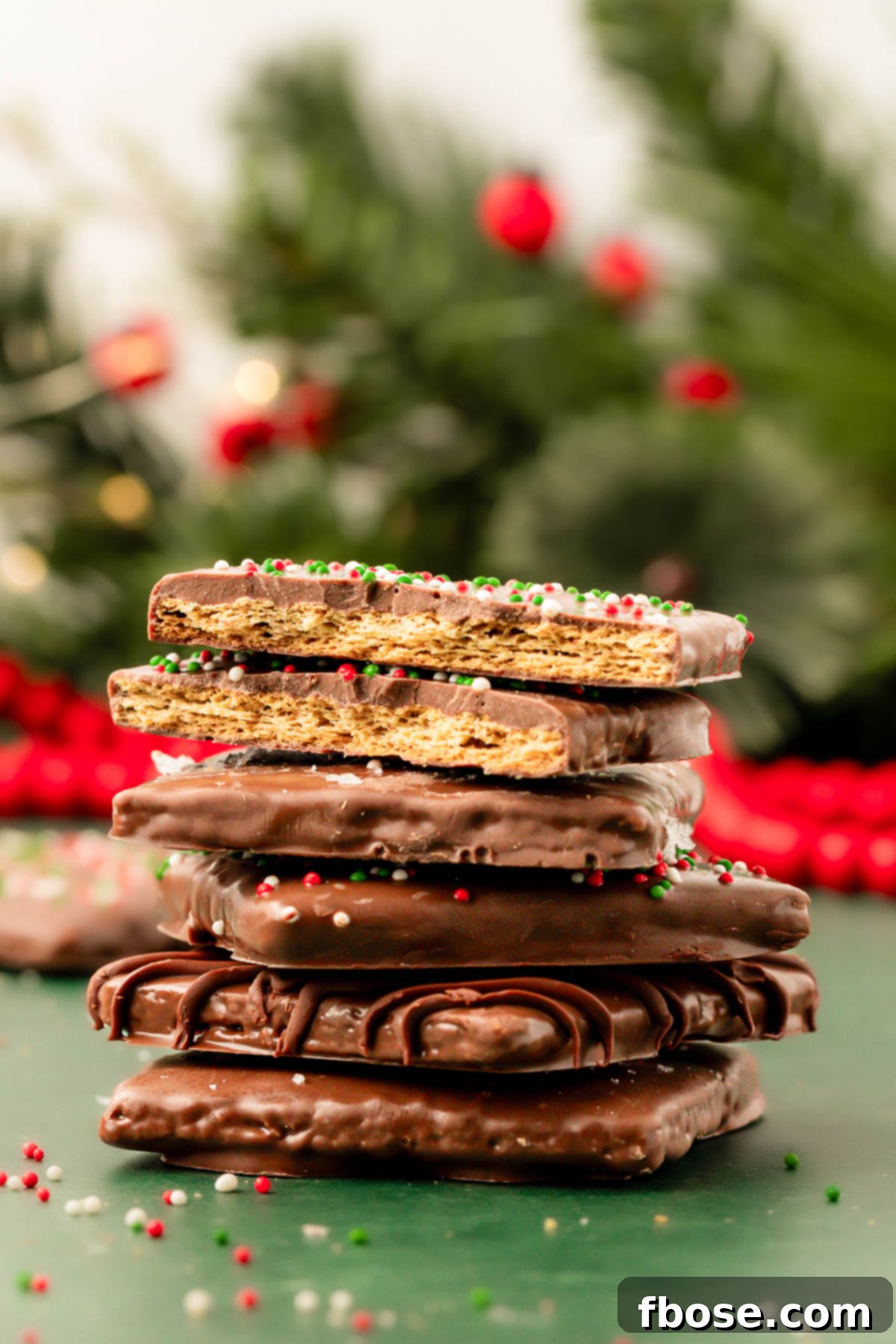 Chocolate Graham Delights 8 A stack of chocolate coated graham crackers on a green surface.