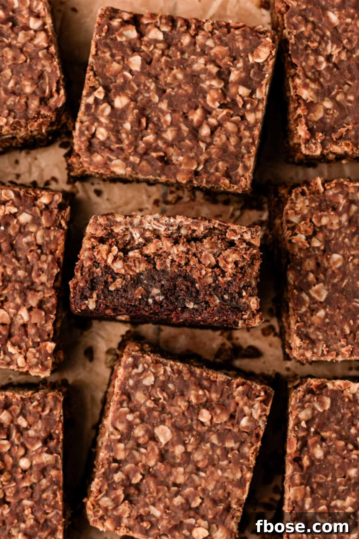 Effortless Fudgy Cookie Brownie Bars 2 Overhead photo of no bake cookie brownies on a wooden cutting board.
