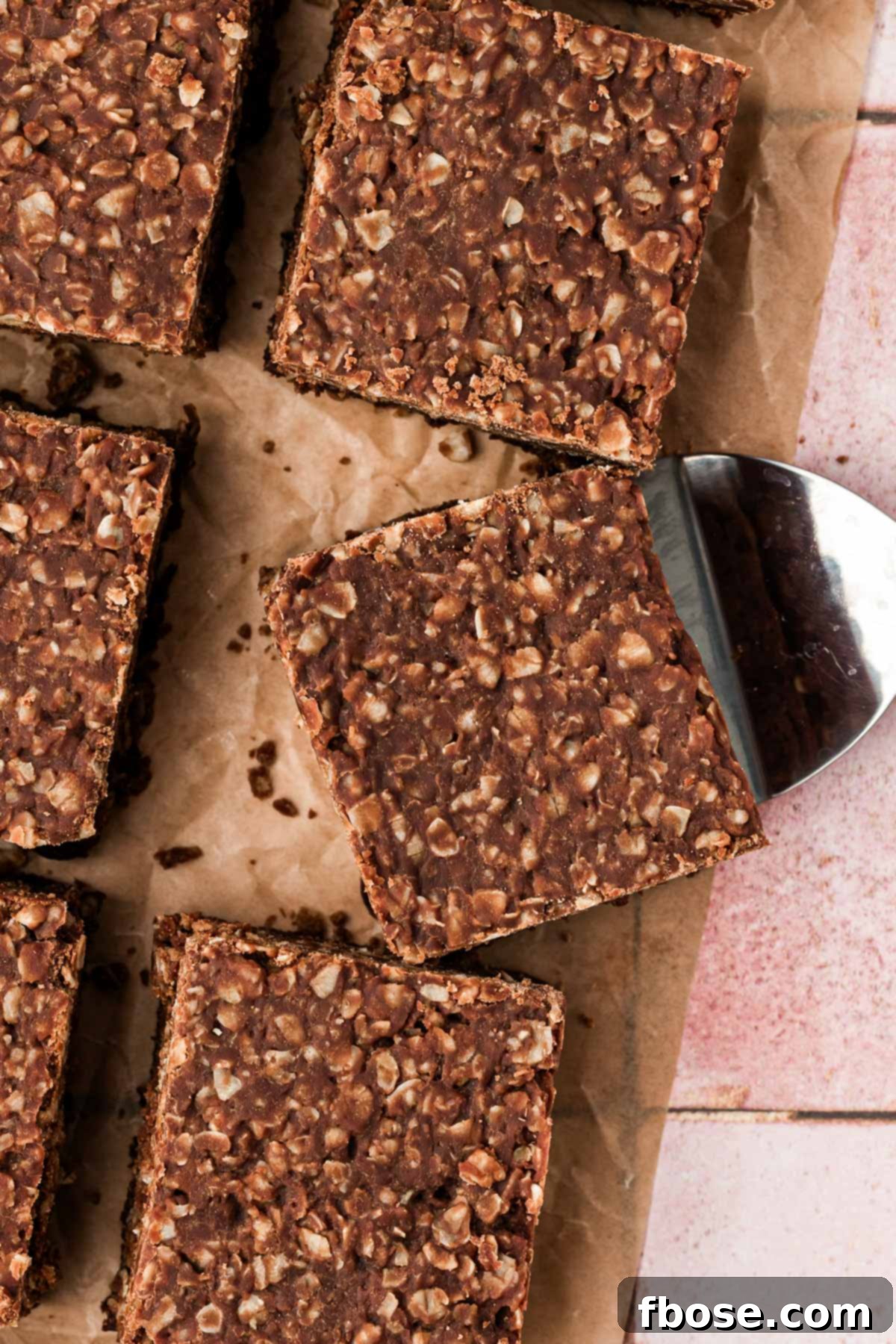 Effortless Fudgy Cookie Brownie Bars 5 Overhead photo of no bake cookie brownies cut up on a table.