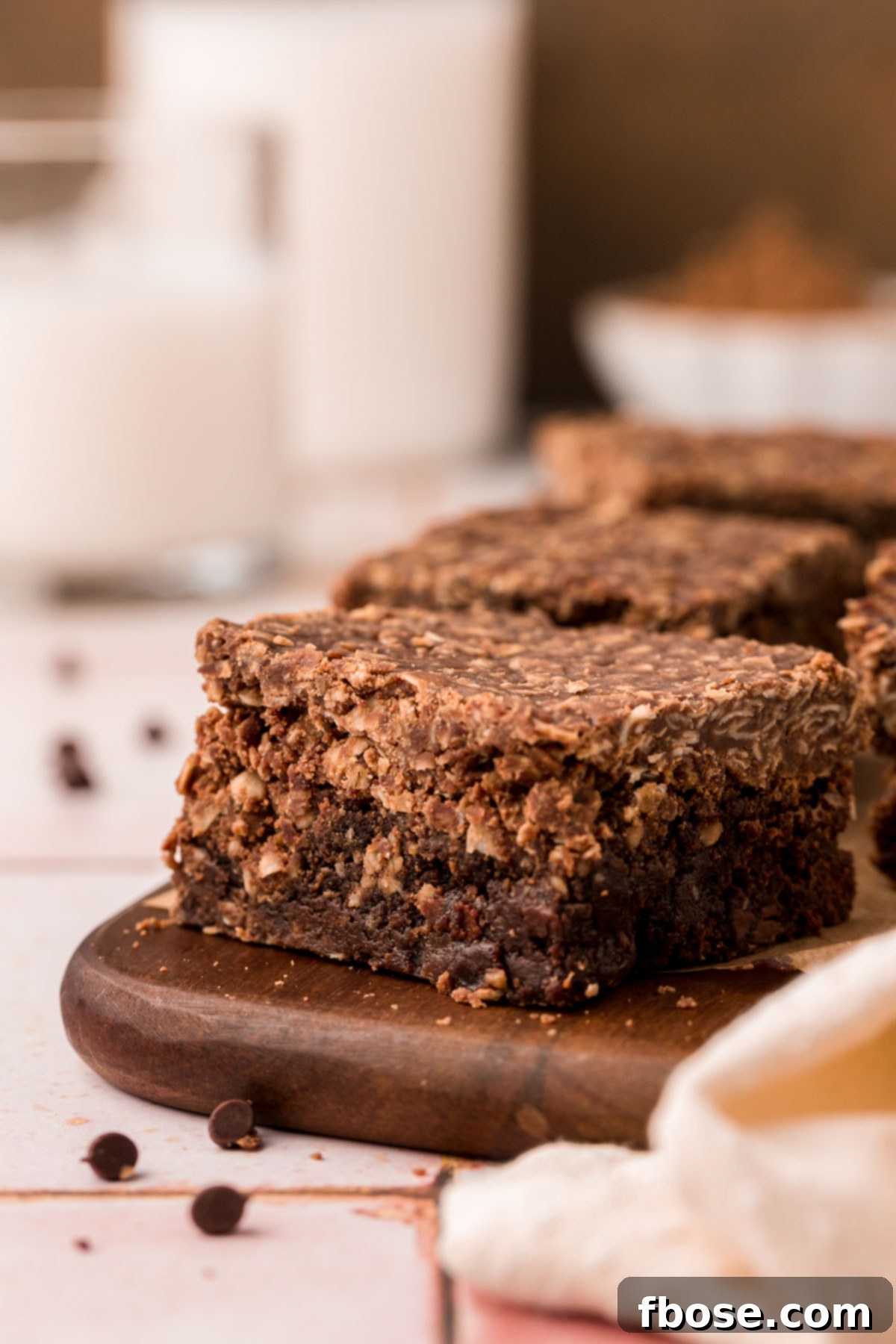 Effortless Fudgy Cookie Brownie Bars 9 No bake cookie brownies on a wooden board.