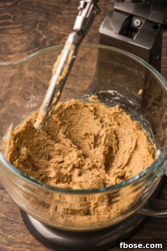 Butter and sugar creamed together in a stand mixer bowl.