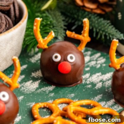 Close up of reindeer oreo balls on a green table napkin, invitingly presented.