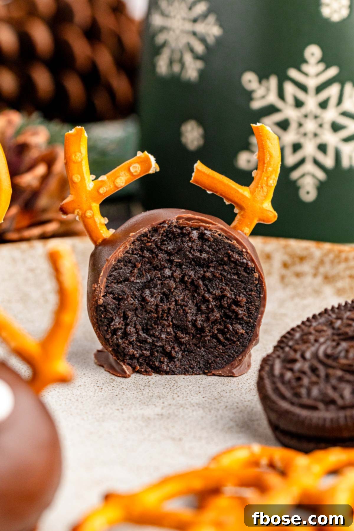 A Reindeer Oreo Ball cut in half, revealing the rich, creamy Oreo filling inside.