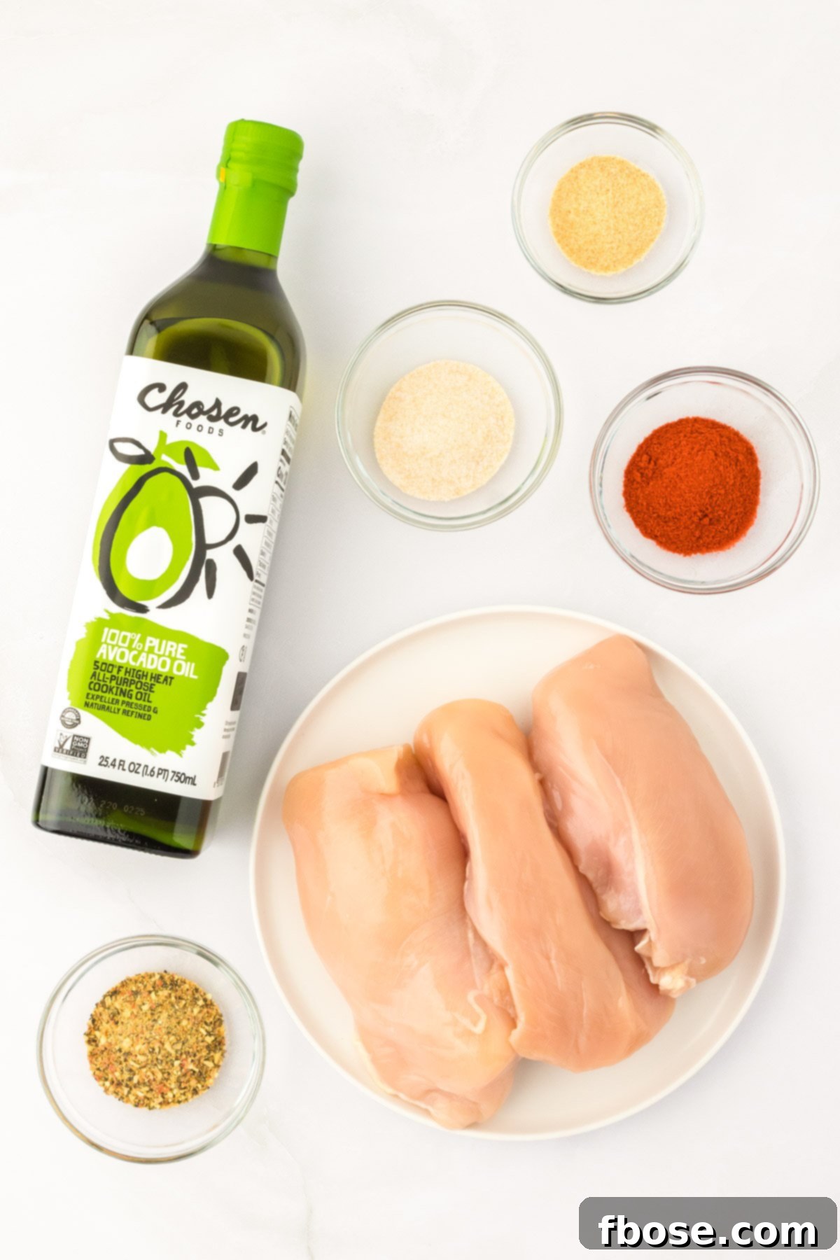 Overhead photo of all the simple ingredients laid out on a white surface, ready to make Juicy Chicken 101.