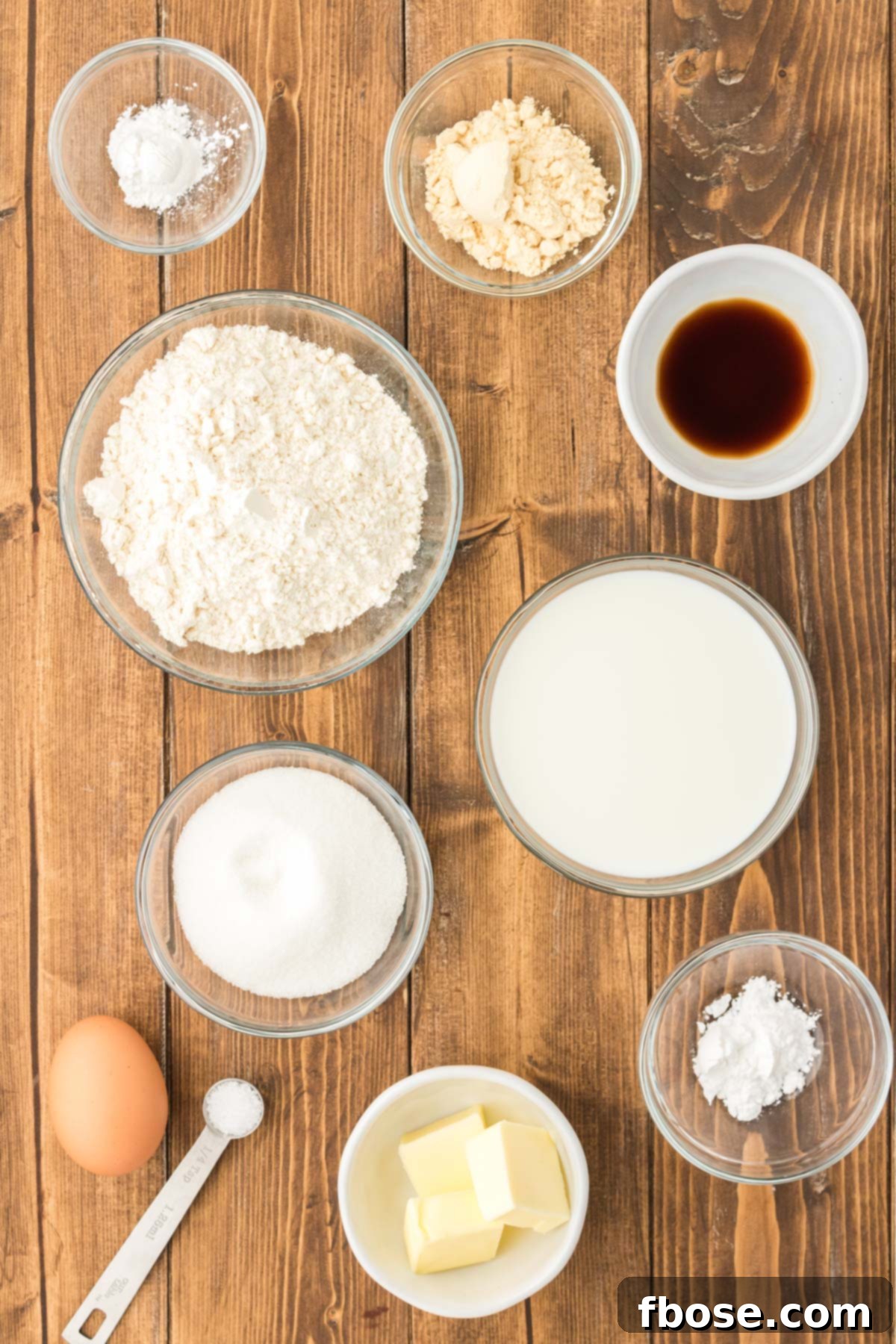 Fluffy Coin Pancakes 4 Overhead photo of all the ingredients meticulously laid out on a rustic wooden table, ready to be combined to make silver dollar pancakes.