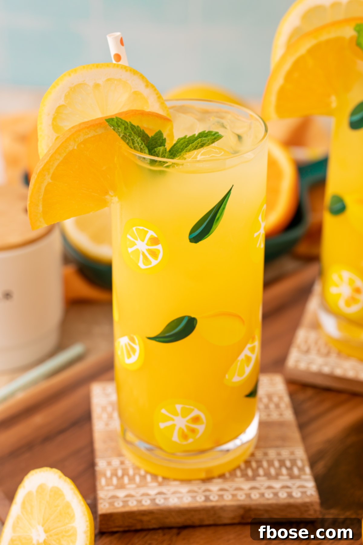Sunkissed Orangeade 3 A close-up view of a glass of bright orangeade with ice and an orange slice garnish, highlighting its refreshing appeal.