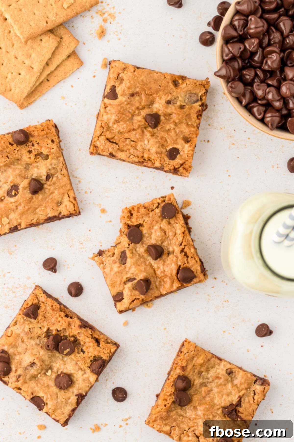 An overhead photo of perfectly baked and sliced graham cracker bars arranged on a table, showcasing their golden brown tops and chocolatey centers.