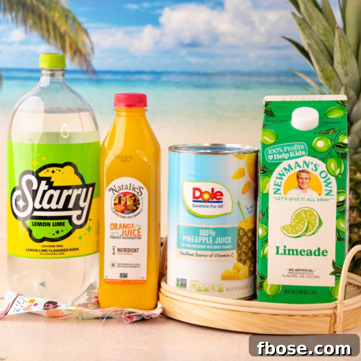 All the fresh and vibrant ingredients needed to make delicious pineapple punch laid out on a clean table.