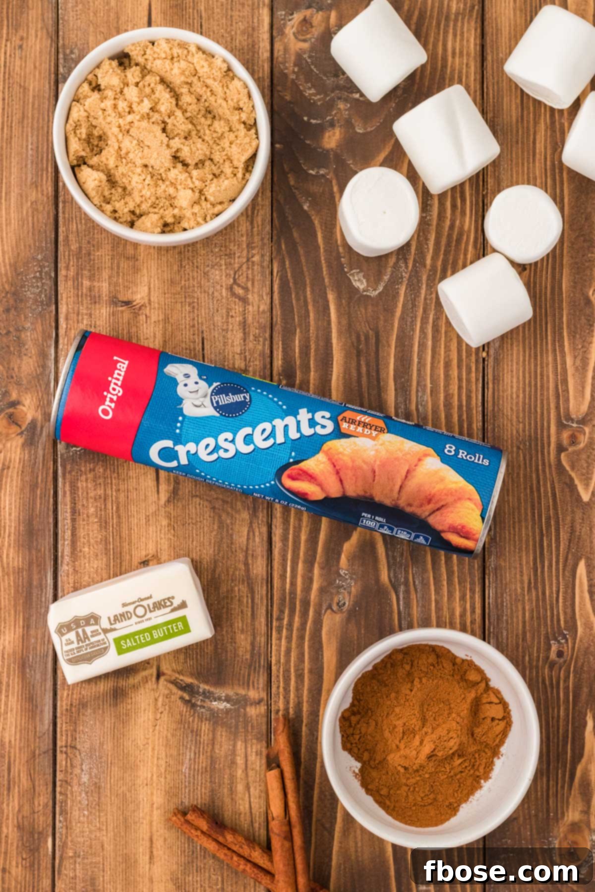 Ingredients to make resurrection rolls on a wooden table.