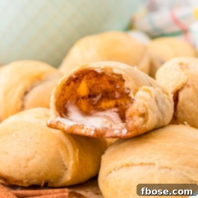 Resurrection rolls together on a table, the top one is cut in half revealing the empty interior where the marshmallow was.