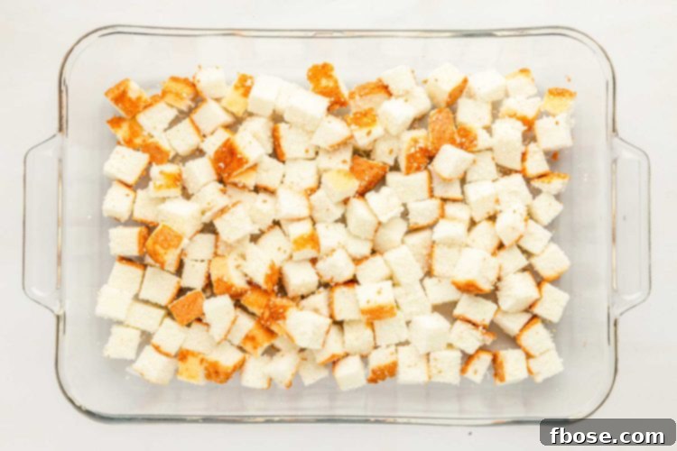 Cubed angel food cake forming the first layer in a glass dish.