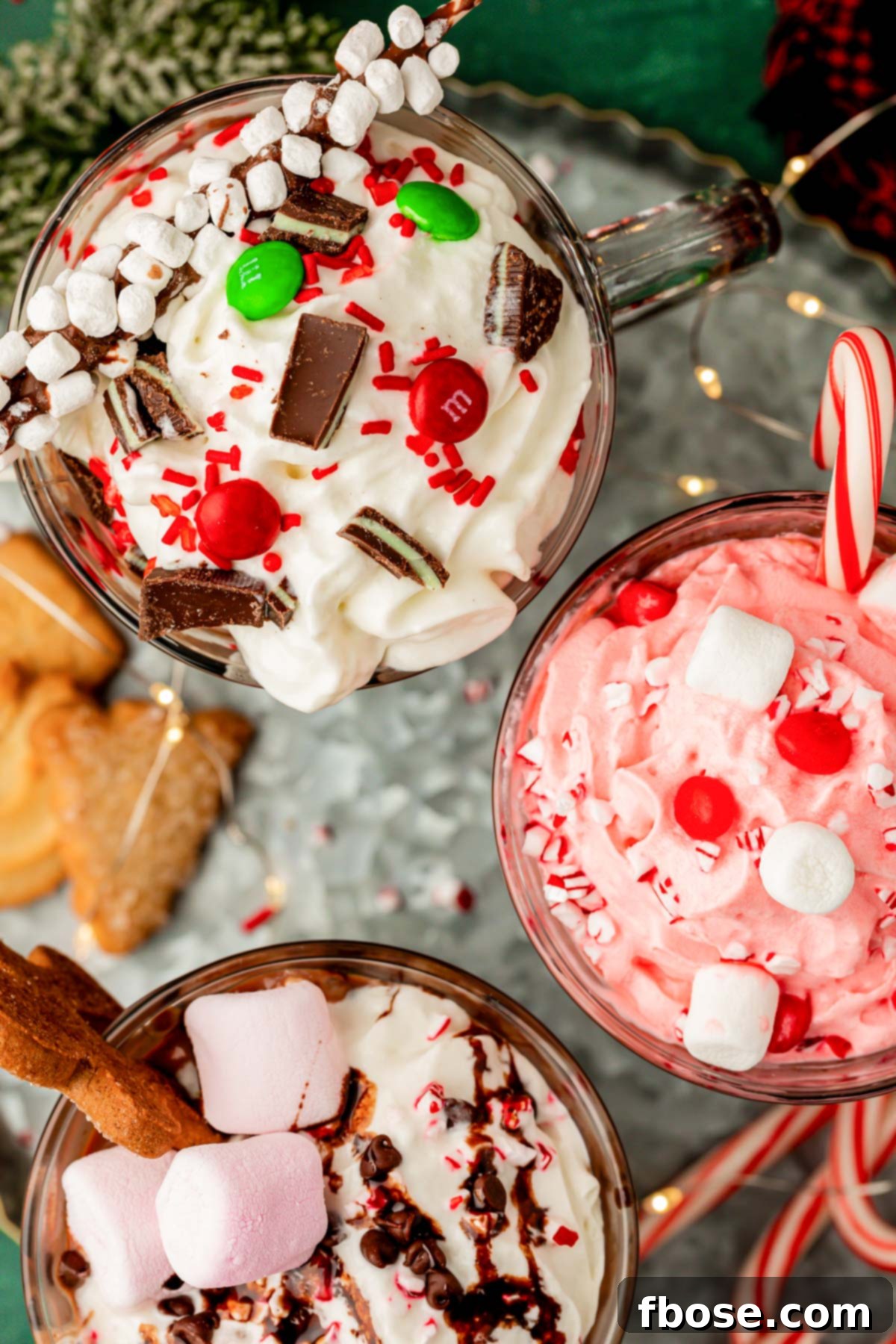 Overhead photo of hot chocolate in mugs with various toppings.