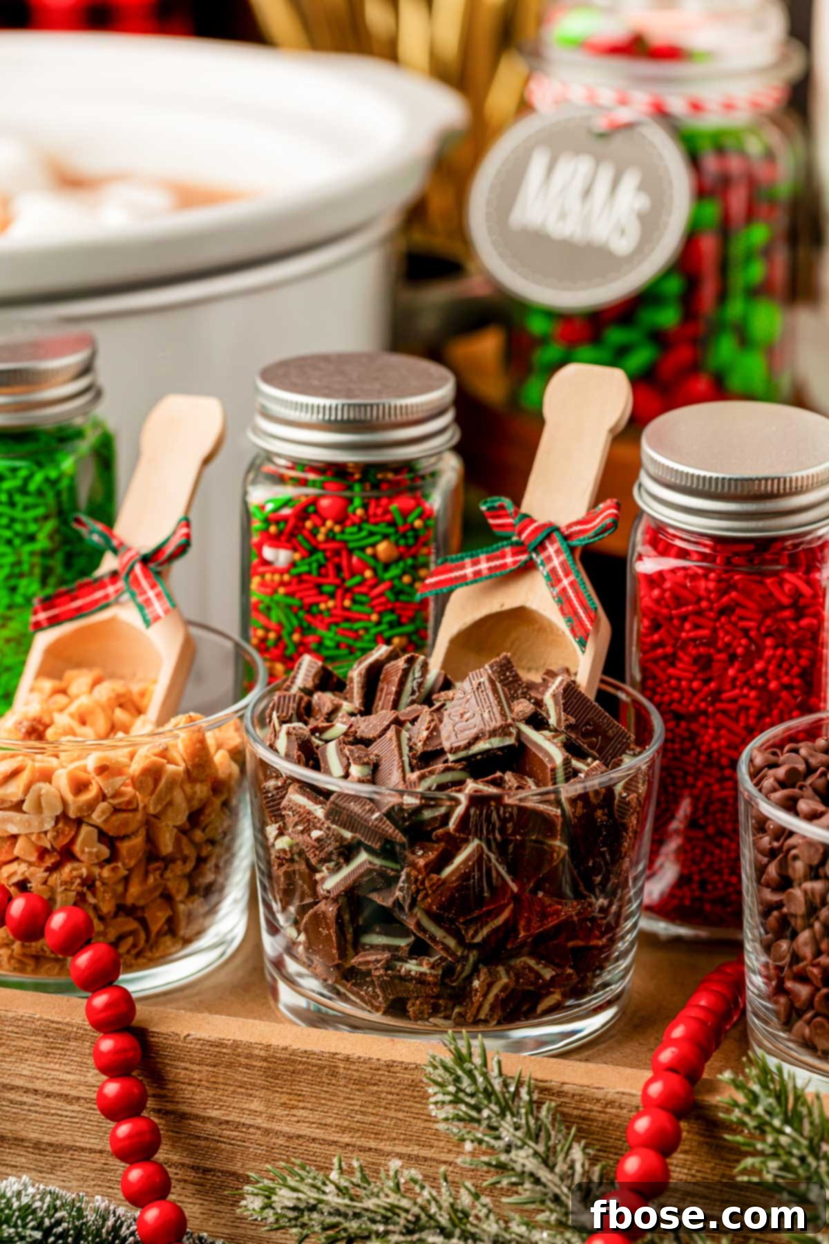 Toppings for a hot cocoa bar in jars on a table.