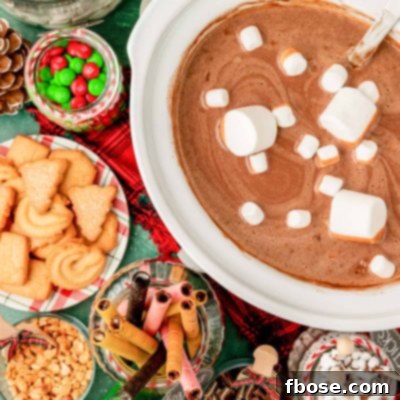 Overhead photo of a crockpot of hot chocolate with ingredients to add to it.