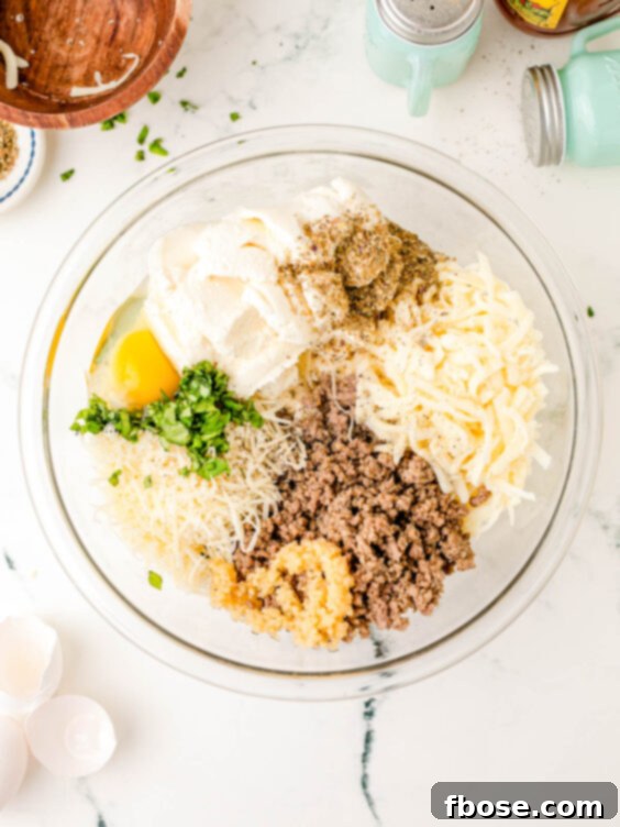 A bowl filled with a creamy ricotta cheese mixture, ready to be spread on lasagna noodles.